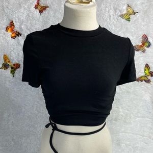 Black crop top with an open back. Ties around